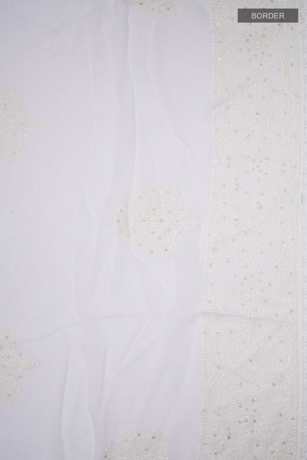 Border image of White Blended Chiffon Saree with Embroidery on the body and Embroidery Border. 