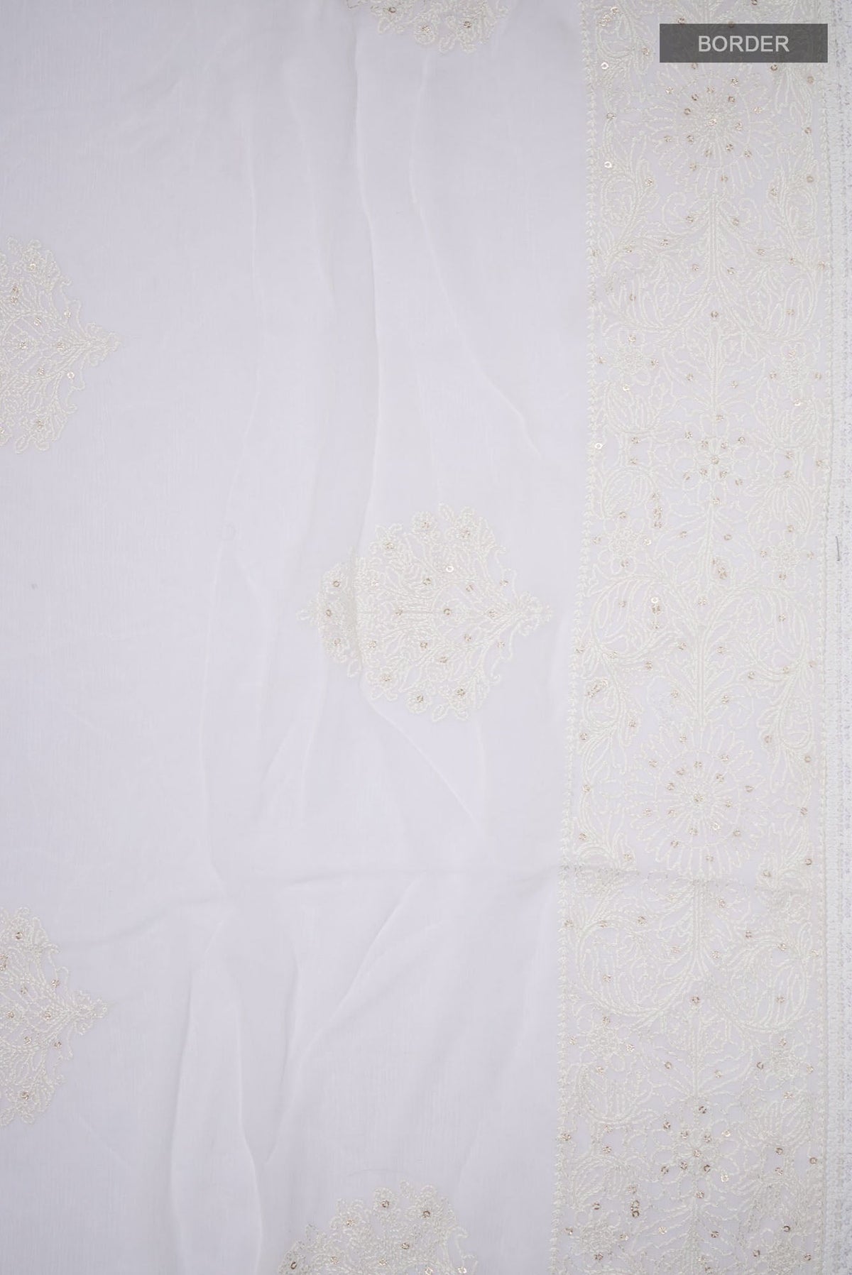Border image of White Blended Chiffon Saree with Embroidery on the body and Embroidery Border. 