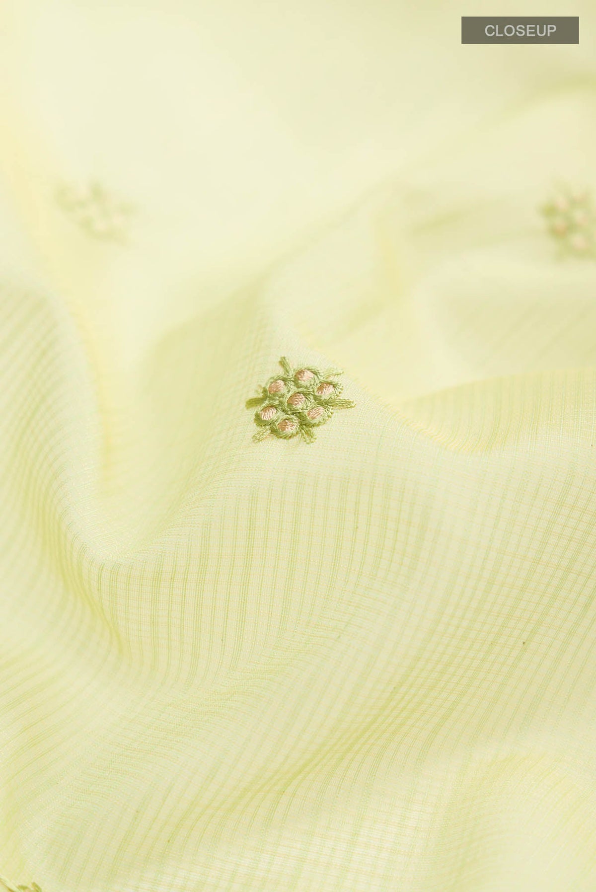 Close up of Green Blended Kota Cotton Saree with Embroidery on the body and Zari Border.  displaying folds
