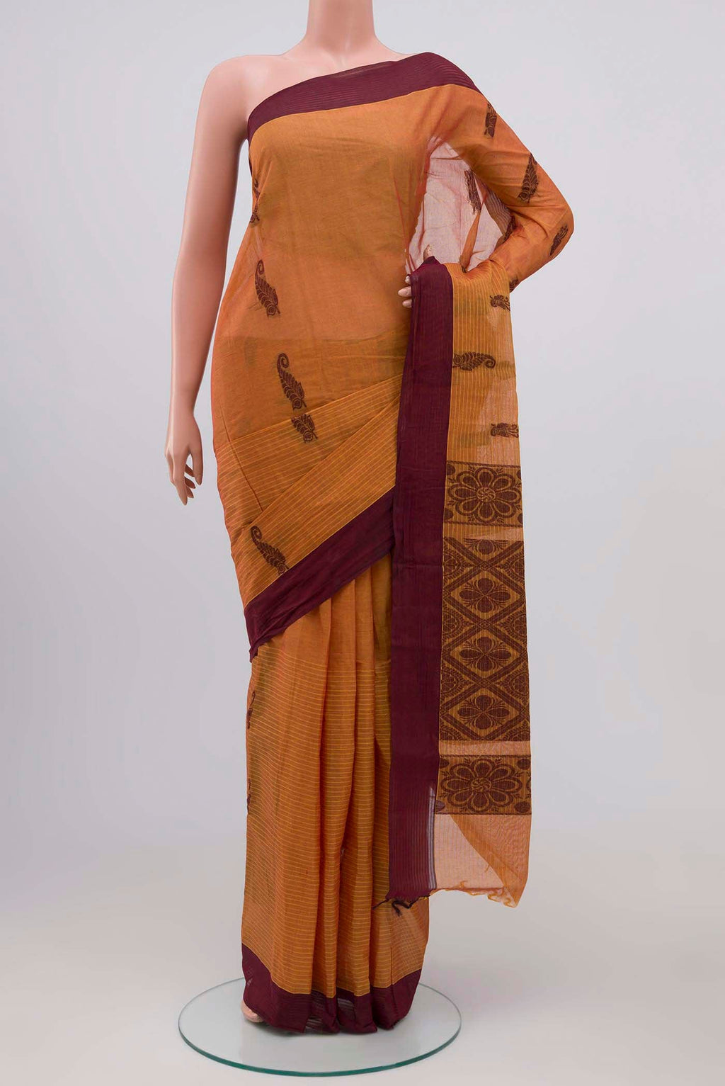 Mustard Kanchi Cotton Saree with Thread Butta on the body and Plain Border.  displayed on a mannequin