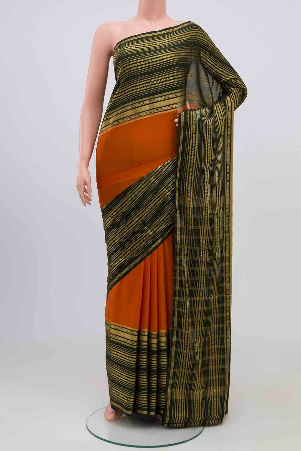 Orange Blended Crepe Saree with Plain Body and Zari Border.  displayed on a mannequin