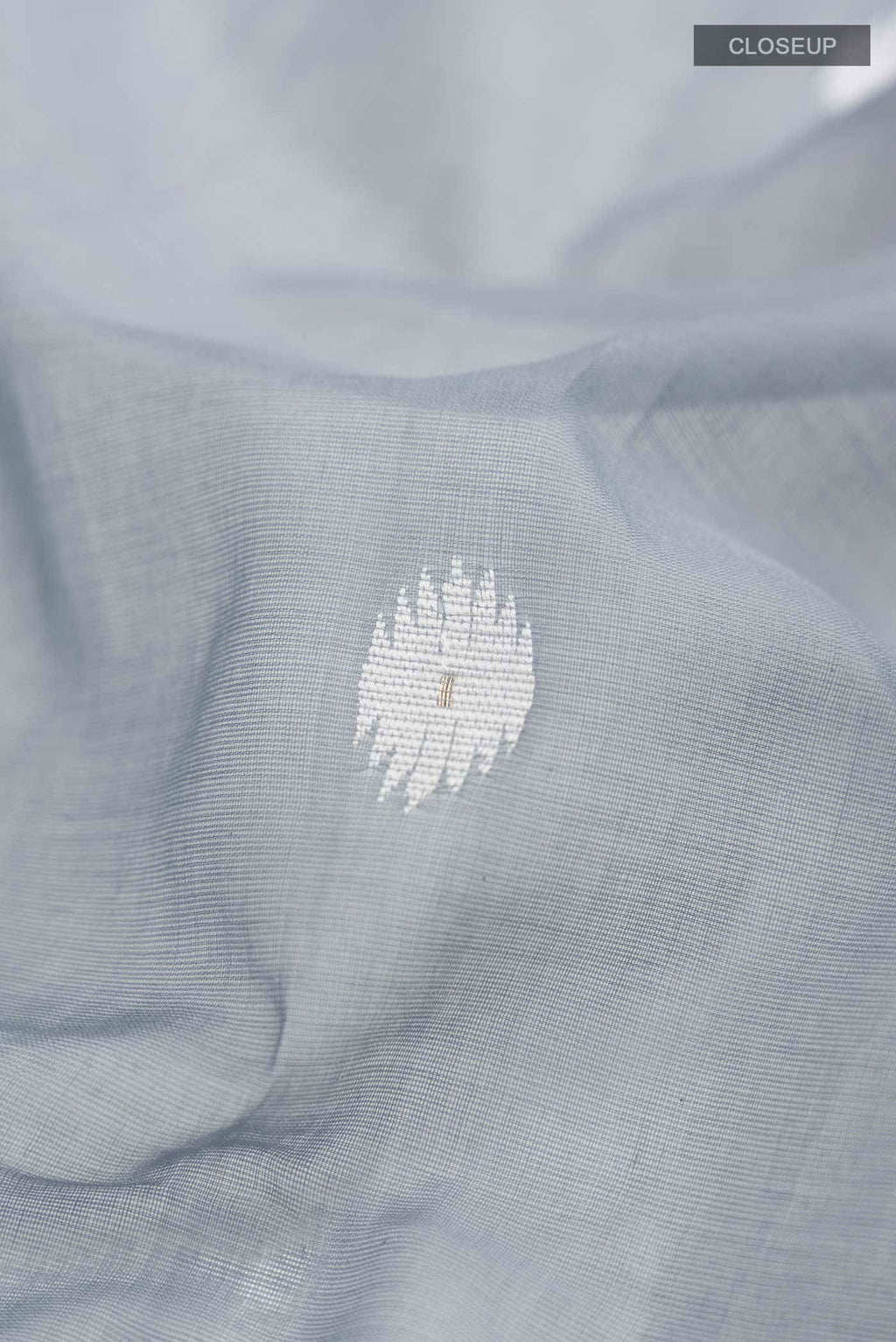 Close up of Grey Bengal Cotton Saree with Jamdani on the body and Zari Border displaying folds