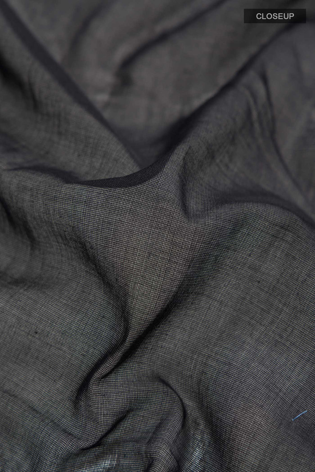 Close up of Black Bengal Cotton Saree with Plain Body and Zari Border displaying folds