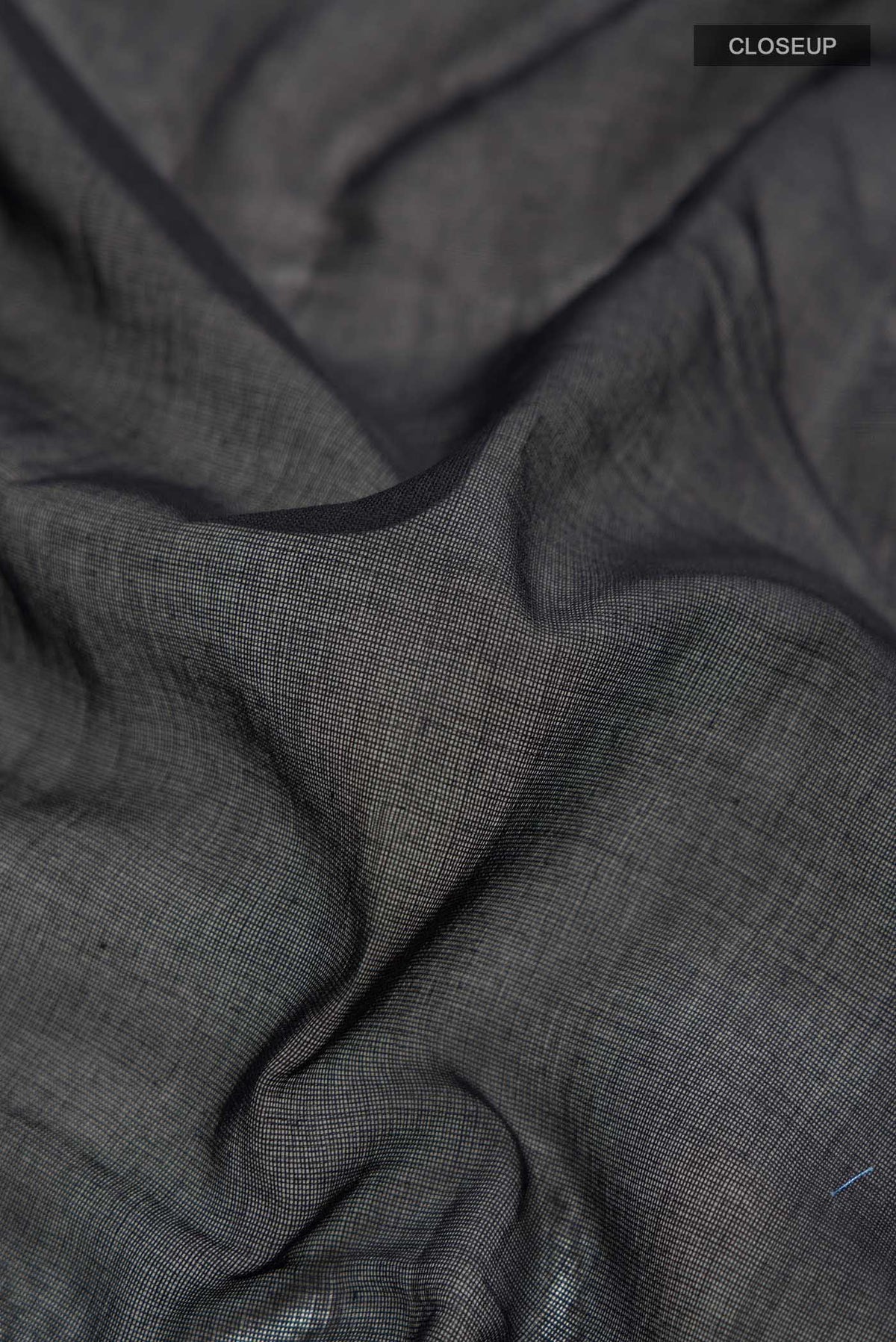 Close up of Black Bengal Cotton Saree with Plain Body and Zari Border displaying folds