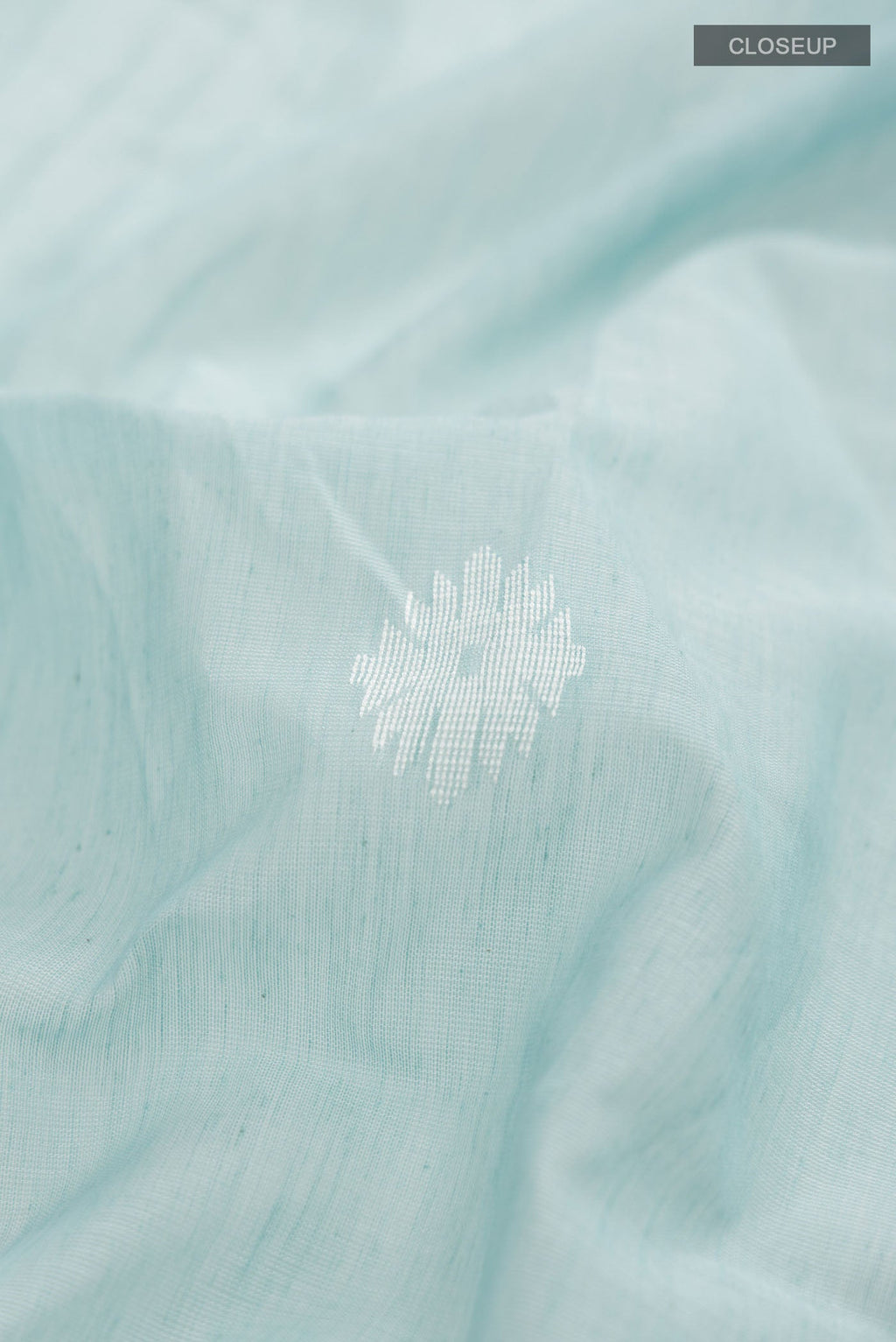 Close up of Sea Green Bengal Cotton Saree with Thread Butta on the body and Zari Border displaying folds