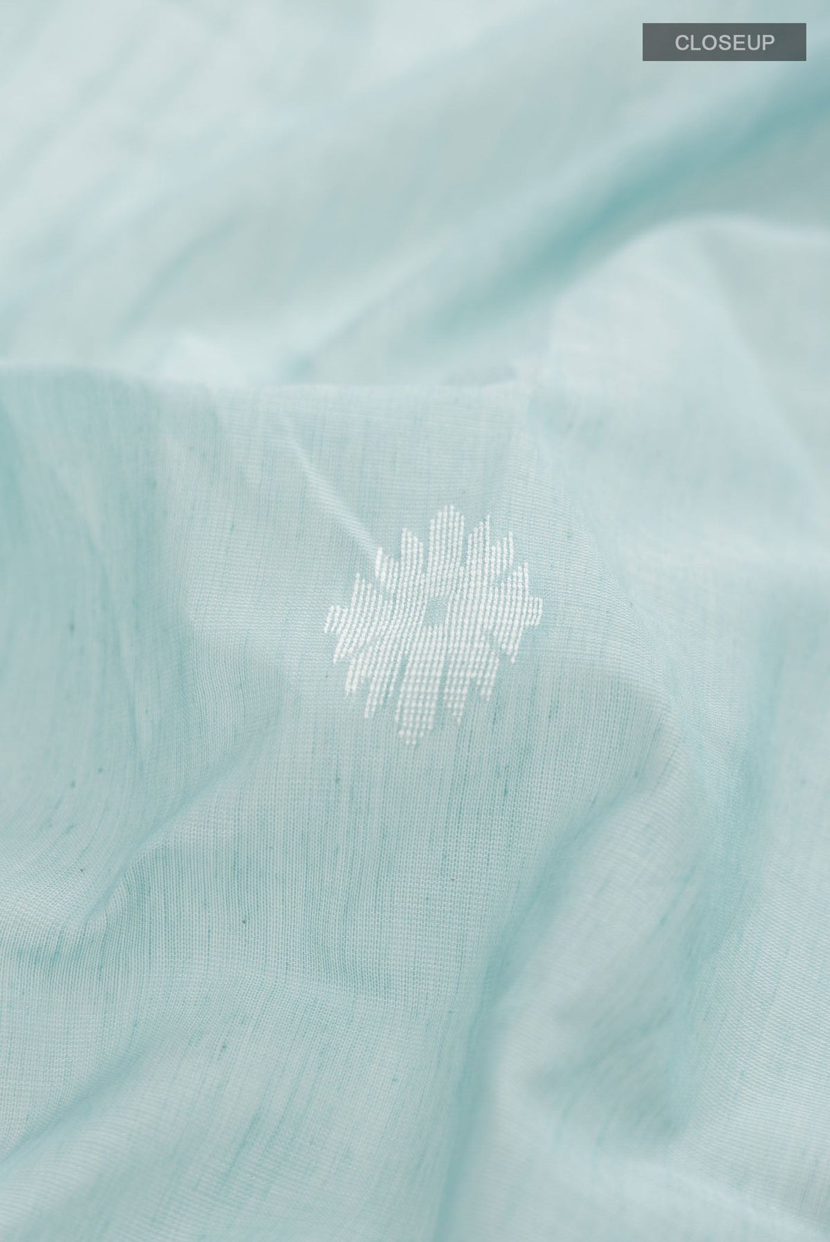 Close up of Sea Green Bengal Cotton Saree with Thread Butta on the body and Zari Border displaying folds