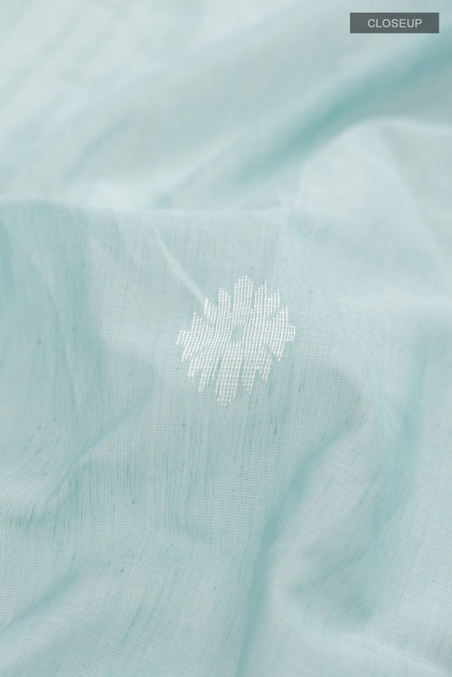 Close up of Sea Green Bengal Cotton Saree with Thread Butta on the body and Zari Border displaying folds
