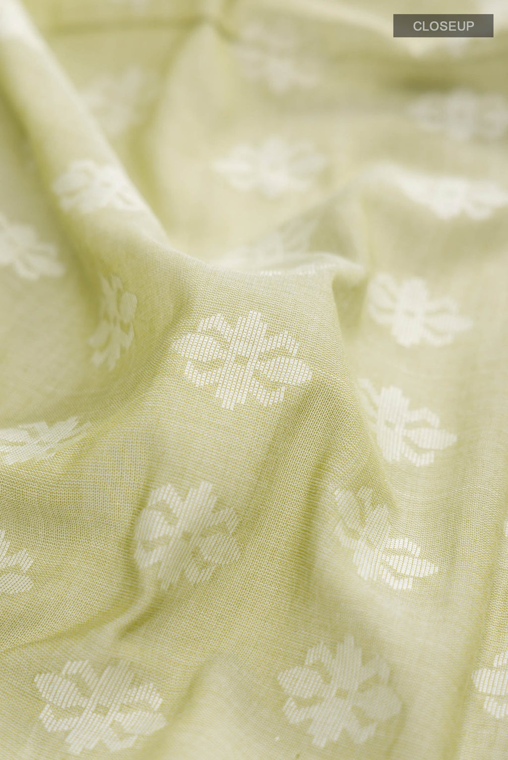 Close up of Light Green Bengal Cotton Saree with Jamdani on the body and Thread Border displaying folds