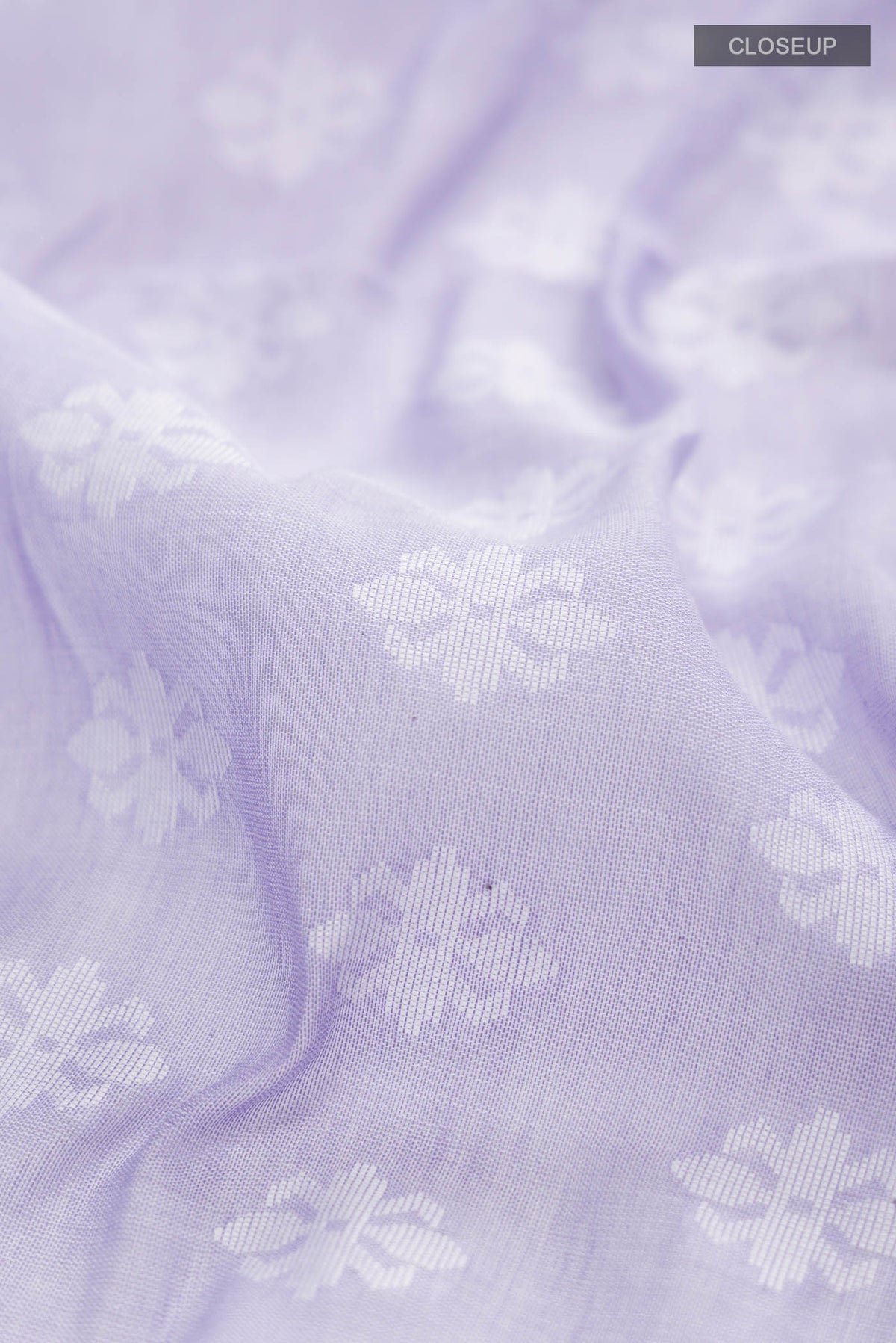 Close up of Lavender Bengal Cotton Saree with Jamdani on the body and Thread Border displaying folds