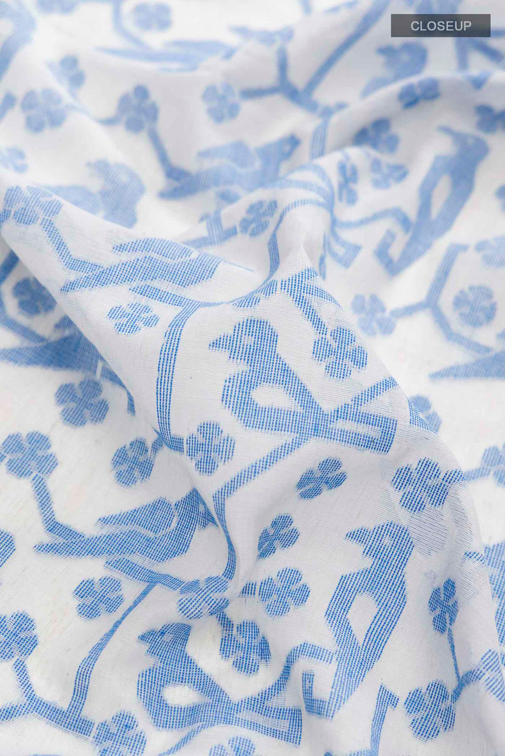 Close up of Cream Bengal Cotton Saree with Jamdani on the body and Thread Border displaying folds