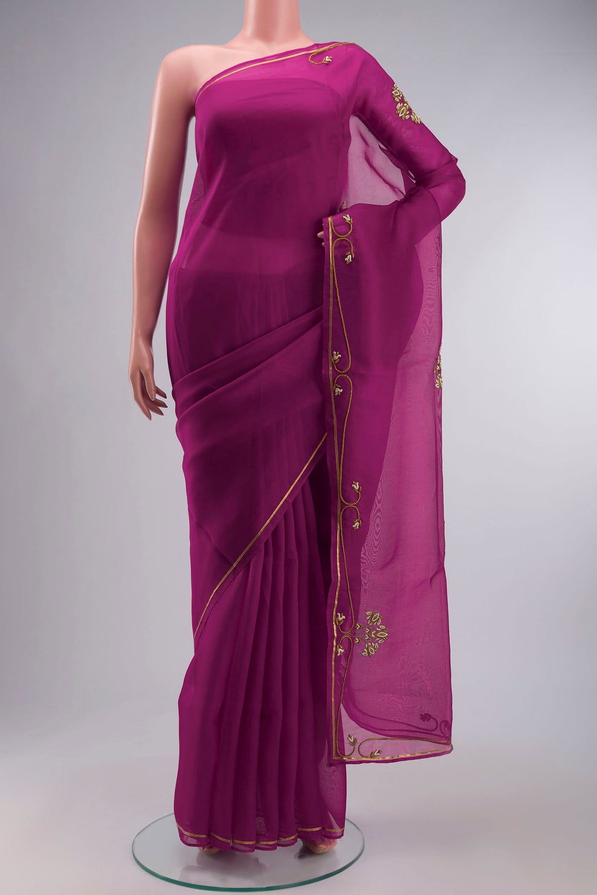 Magenta Organza Silk Saree with Embroidery on the body and Embroidery Border displayed on a mannequin