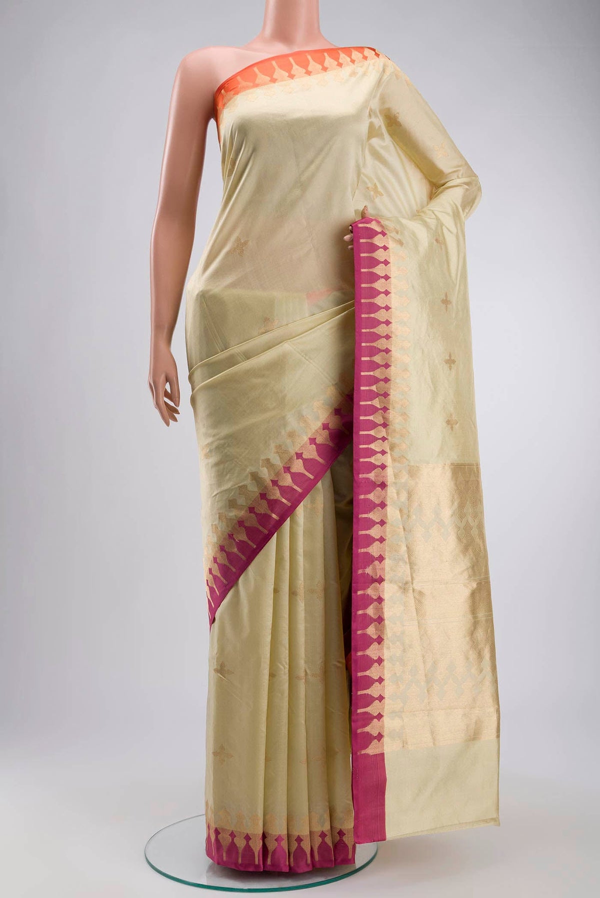 Cream Banarasi Katan Silk Saree with Zari Butta on the body and Zari Border displayed on a mannequin