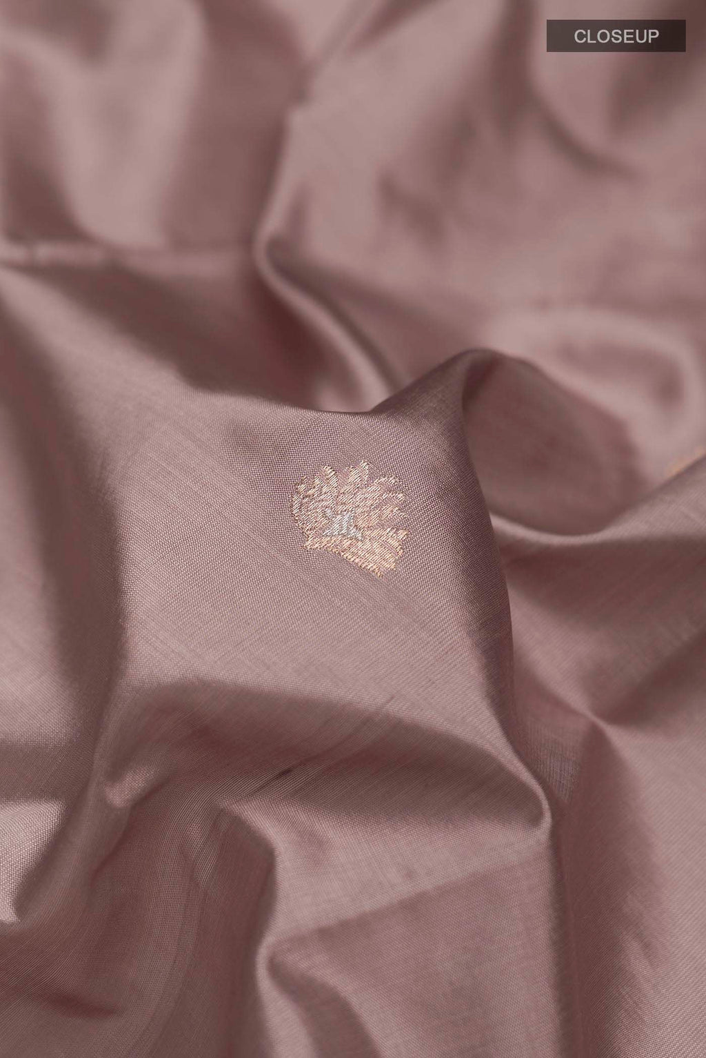 Close up of Mauve Banarasi Katan Silk Saree with Zari Butta on the body and Zari Border displaying folds