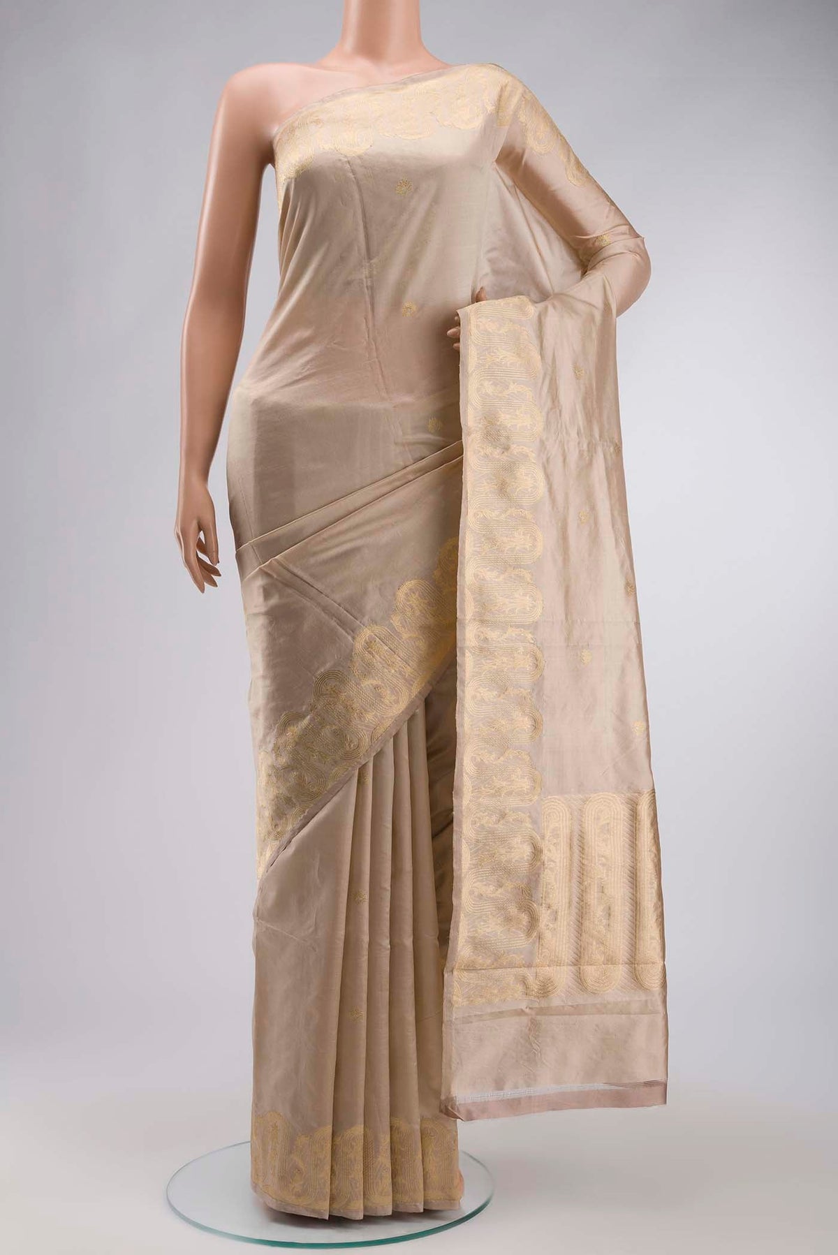 Beige Banarasi Katan Silk Saree with Zari Butta on the body and Zari Border displayed on a mannequin