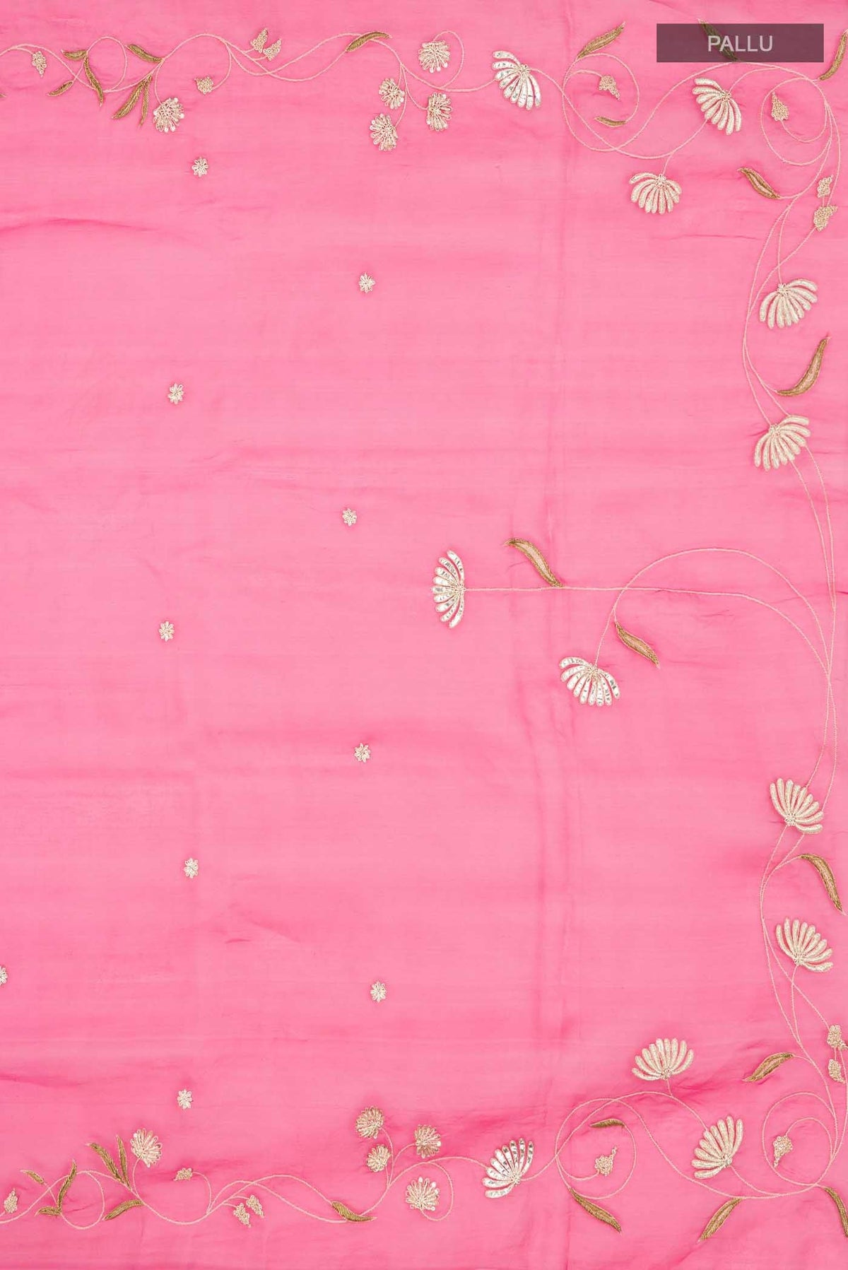 Close up image of the pallu of Bahar, crafted in silk organza, features delicate pani-zari enriched with zardozi, gota work, and dabka embroidery Its defining element is an off-center floral vine running vertically through the body, breaking symmetry with quiet intent Inspired by Art Nouveau?s flowing lines, the vine is rendered in slender leaves, zari chain-stitched stems, and alternating gota and zardozi flowers The pallu trails gently onto the body in scattered embroidered blooms
