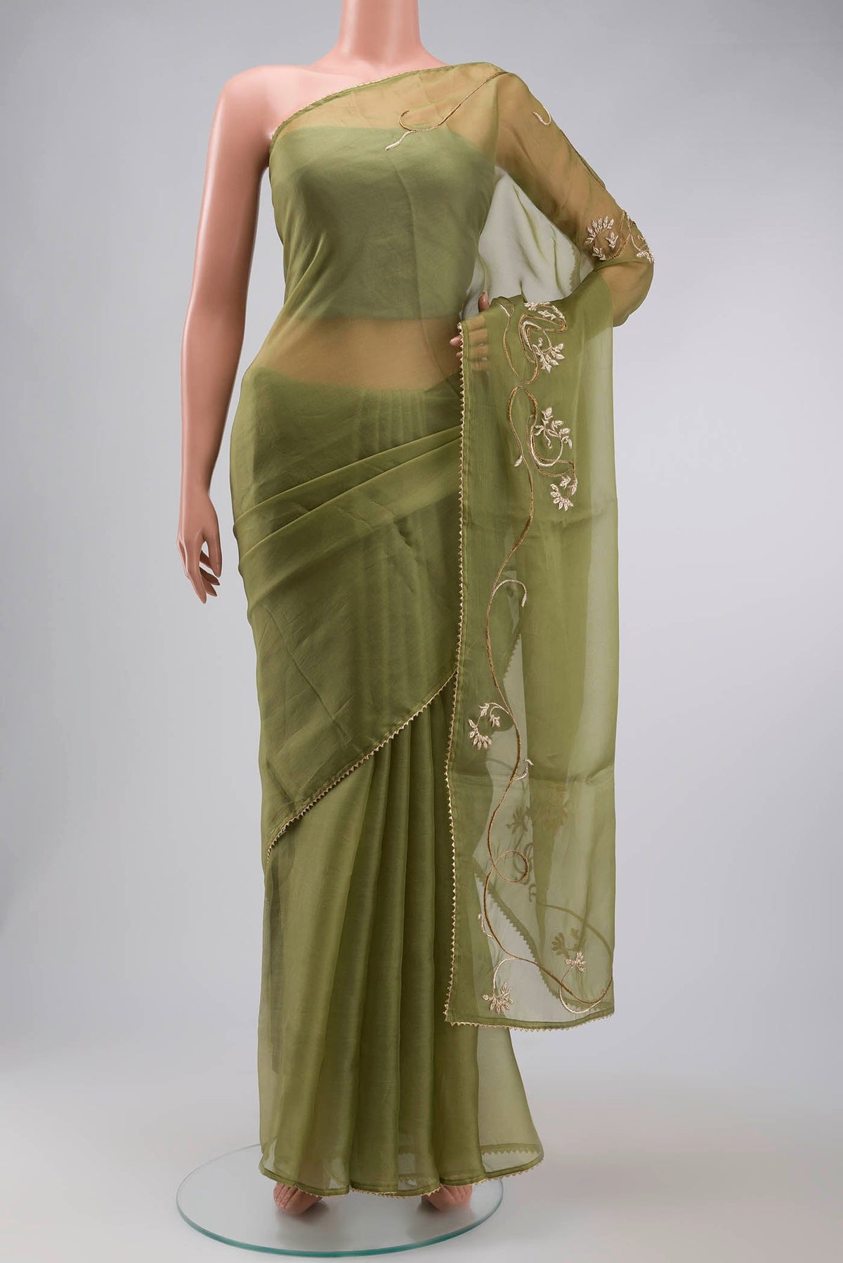 Green Organza Silk Saree with Plain Body and Embroidery Border displayed on a mannequin