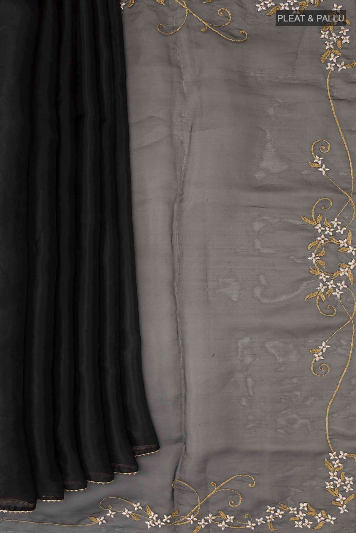 Pleats and pallu of Black Organza Silk Saree with Plain Body and Embroidery Border