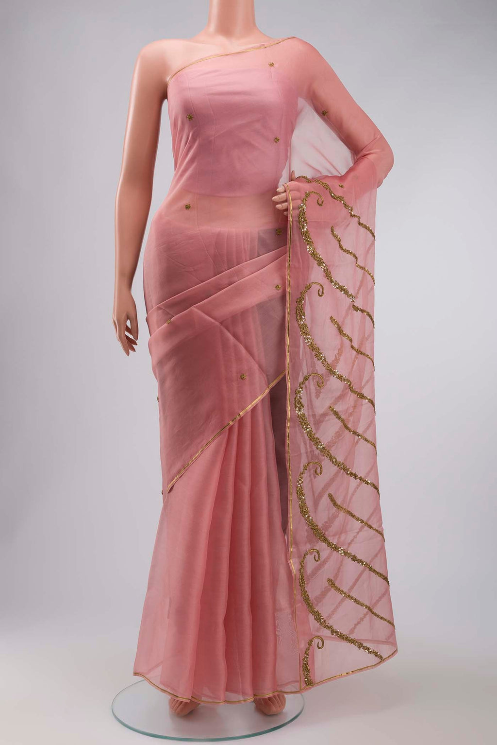 Pink Organza Silk Saree with Embroidery on the body and Zari Border displayed on a mannequin