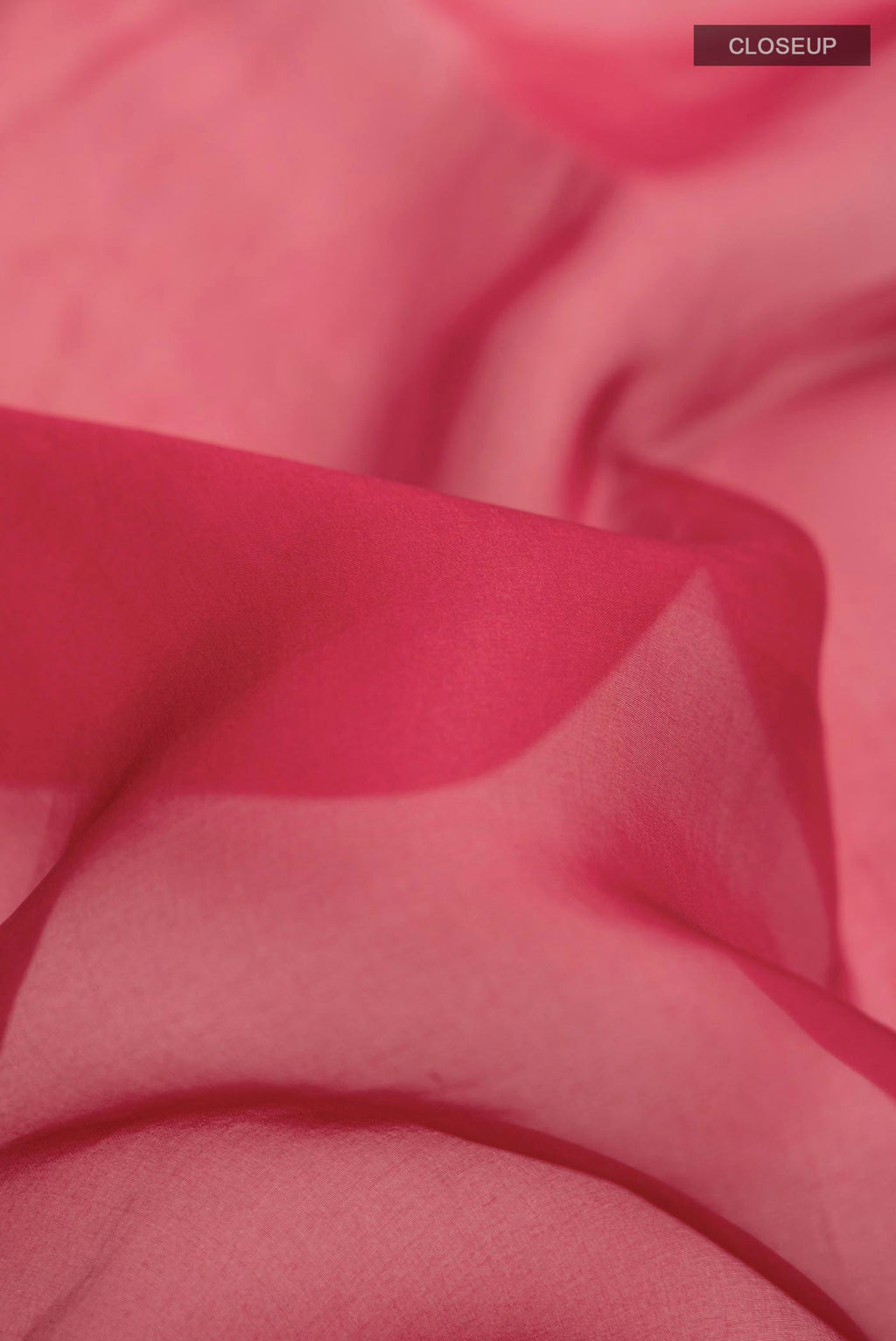 Close up of Maroon Organza Silk Saree with Embroidery on the body and Embroidery Border displaying folds