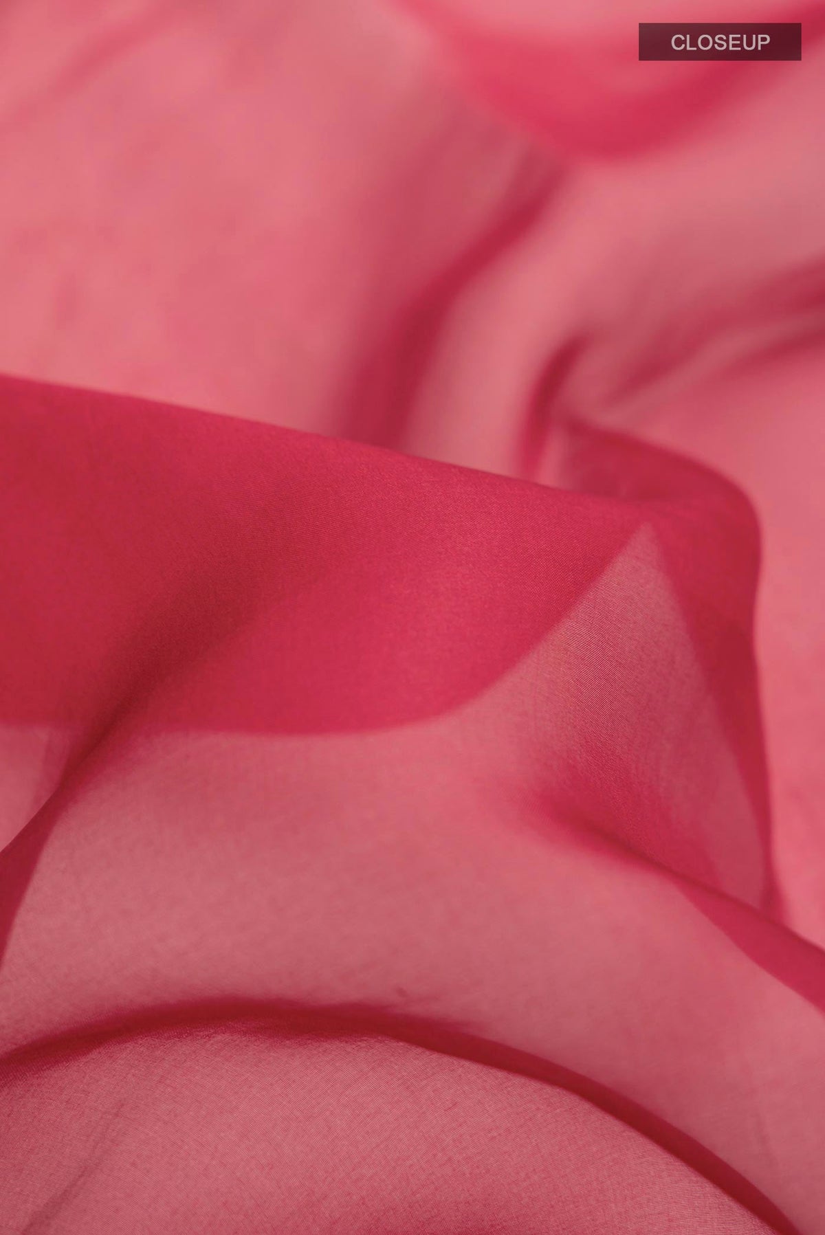 Close up of Maroon Organza Silk Saree with Embroidery on the body and Embroidery Border displaying folds