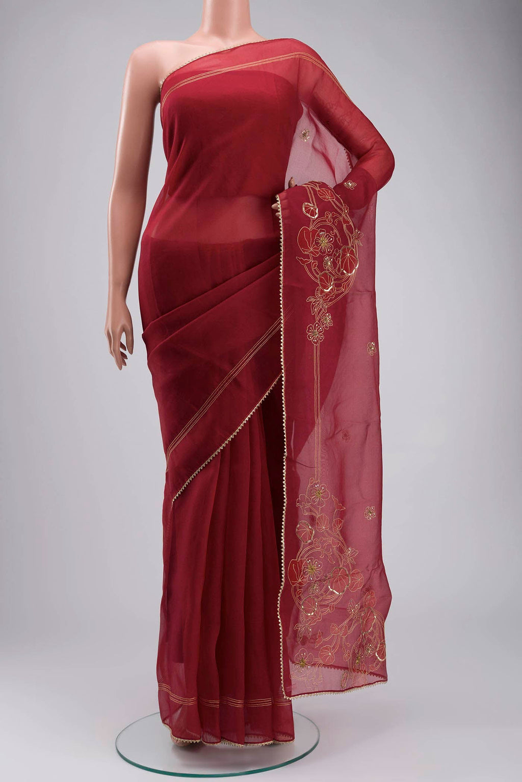 Maroon Organza Silk Saree with Embroidery on the body and Embroidery Border displayed on a mannequin