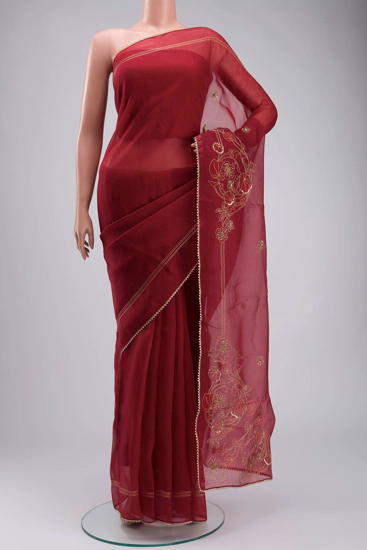 Maroon Organza Silk Saree with Embroidery on the body and Embroidery Border displayed on a mannequin