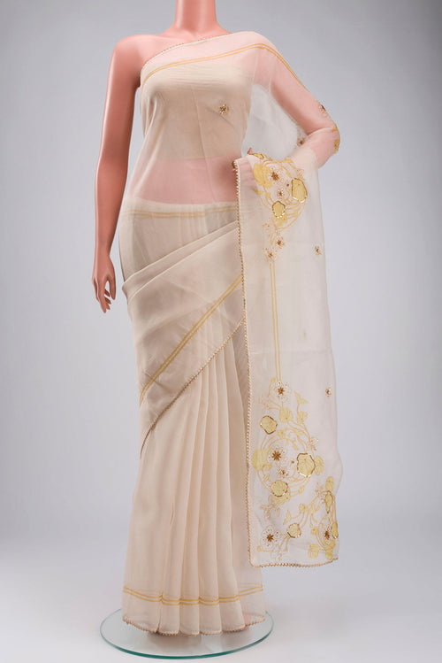 Cream Organza Silk Saree with Plain Body and Embroidery Border displayed on a mannequin