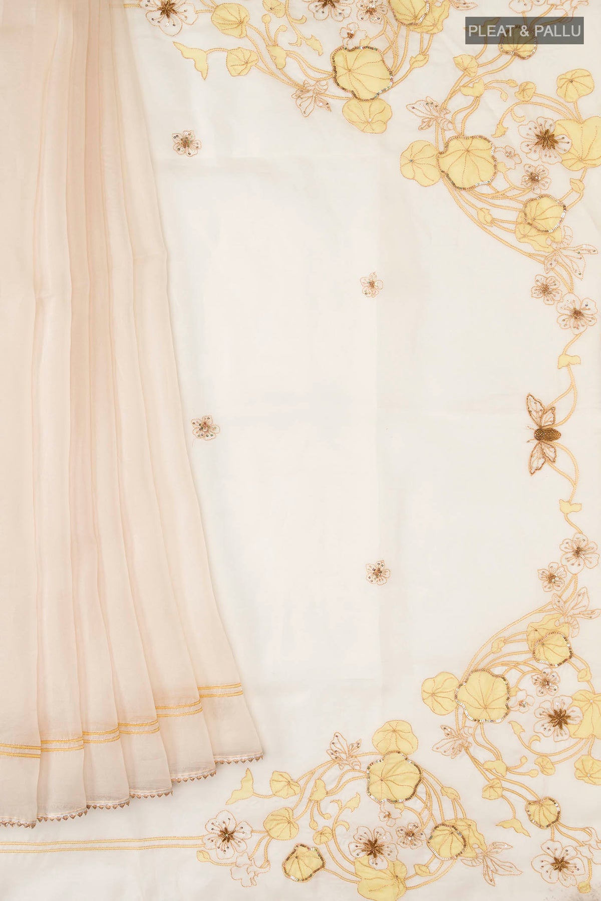 Pleats and pallu of Cream Organza Silk Saree with Plain Body and Embroidery Border