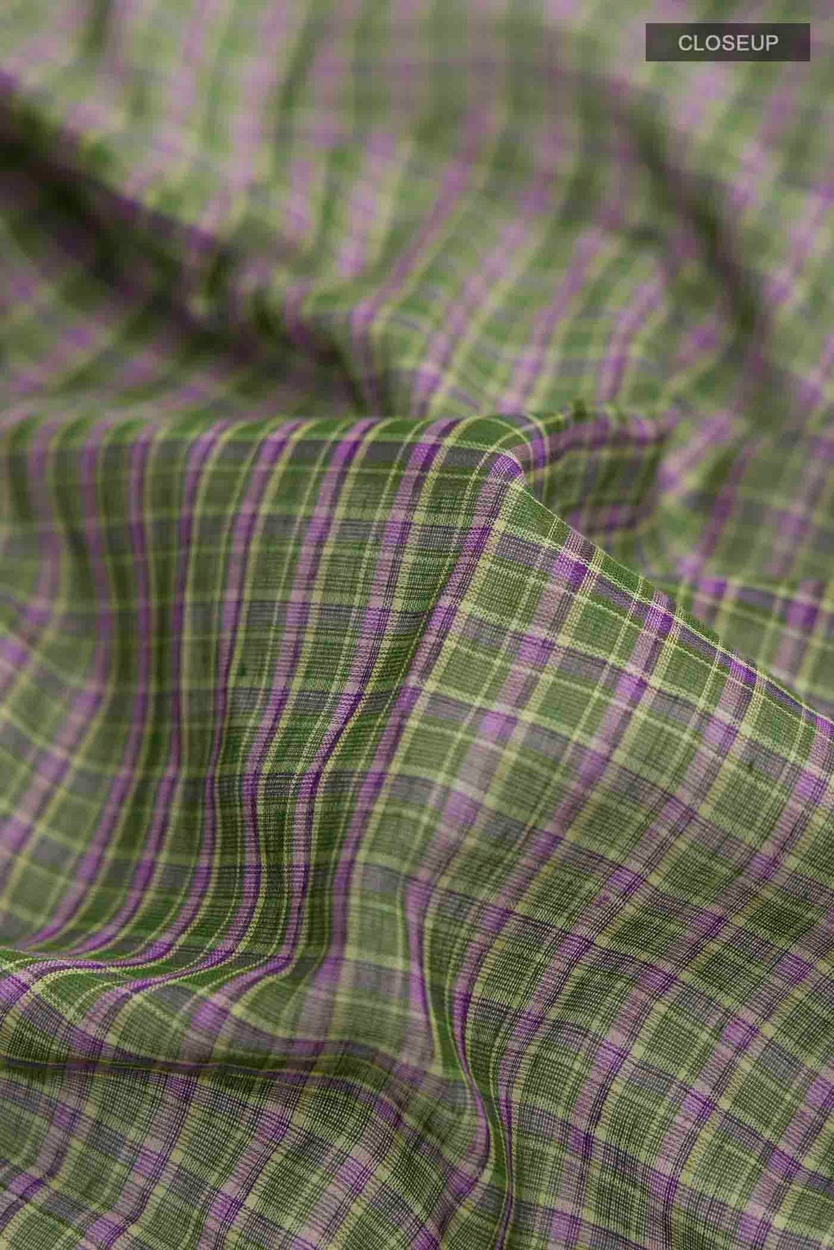 Close up of Patang features fine multi-coloured checks woven using four harmonious hues, creating a lively yet balanced design Translating to ?te)n Hindi, the saree reflects the light, easy spirit of a patang gliding across an open sky The border and pallu are minimal, finished with delicate zari accents that add subtle richness With its balanced play of colour, it makes for a breathable, comfortable drape displaying folds
