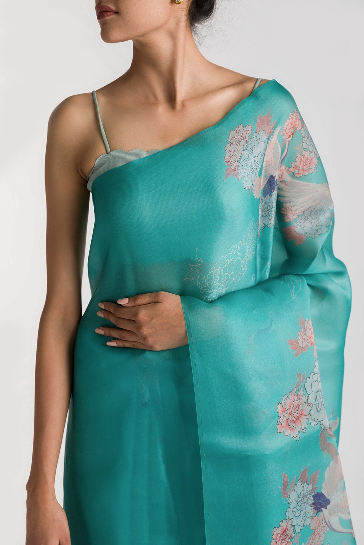 Close up of Light Blue Satin Organza Saree with Bird Print on the body and Without Border displaying folds