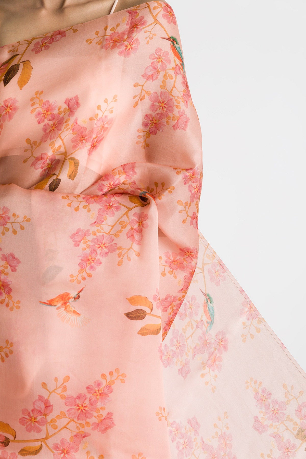 Close up of Peach Satin Organza Saree with Bird Print on the body and Without Border displaying folds