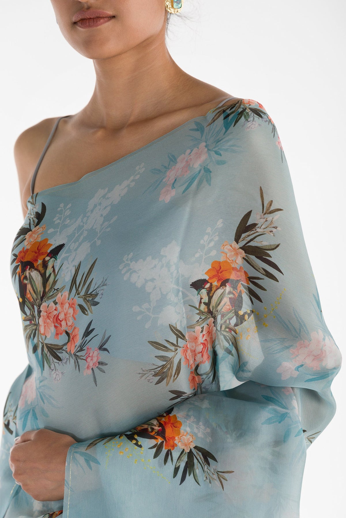 Close up of Blue Satin Organza Saree with Bird Print on the body and Without Border displaying folds