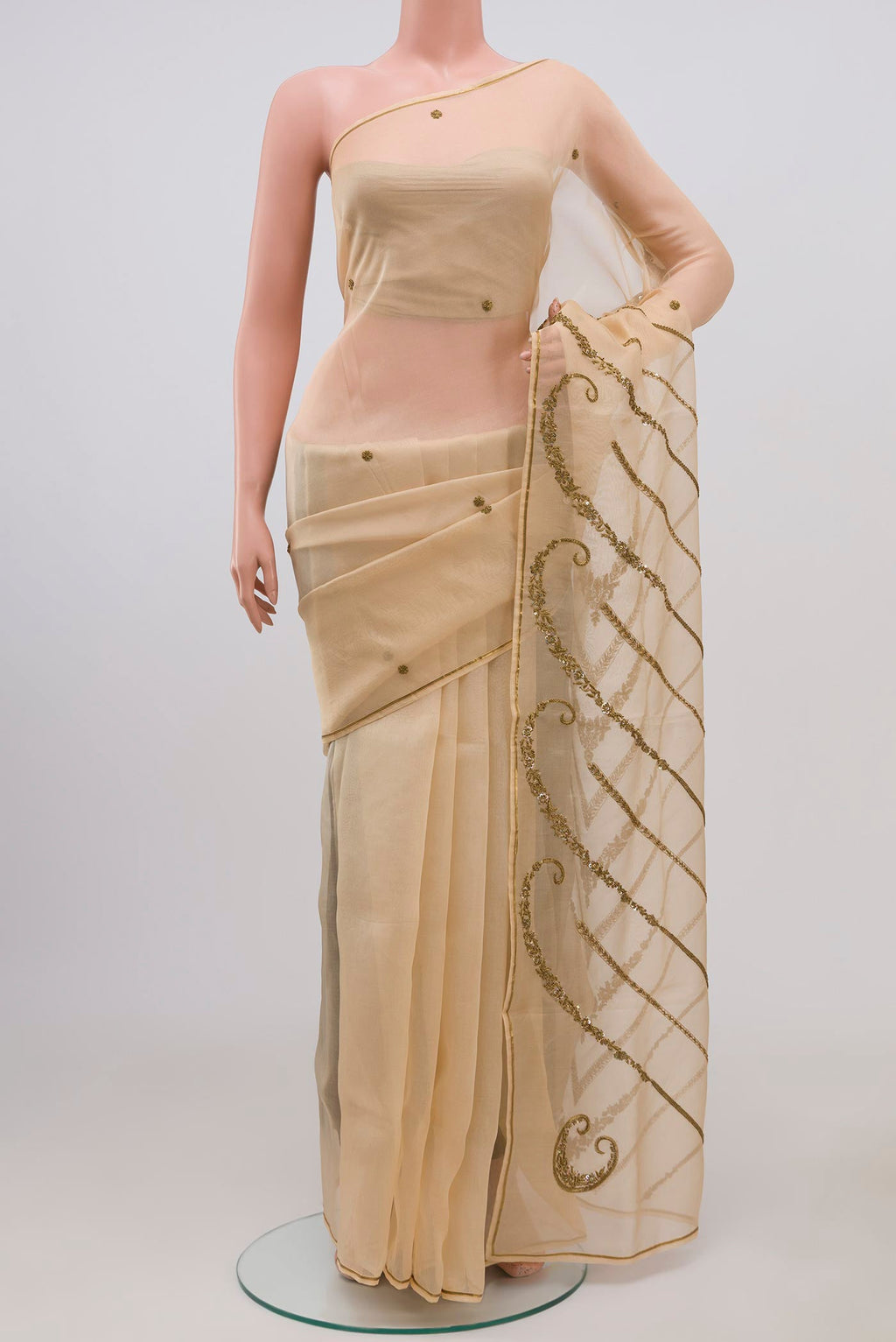 Beige Organza Silk Saree with Embroidery on the body and Embroidery Border displayed on a mannequin
