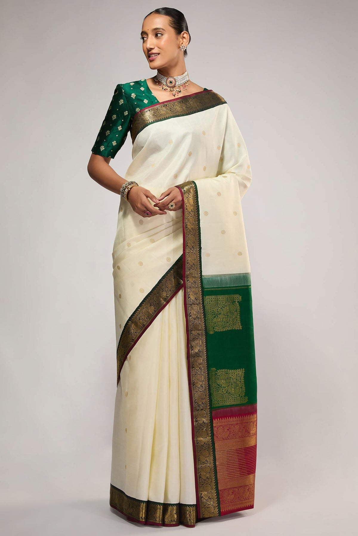Pure Silk Pure Zari Off White Kanchipuram Saree with Zari Butta on the body and Zari Border displayed on a mannequin