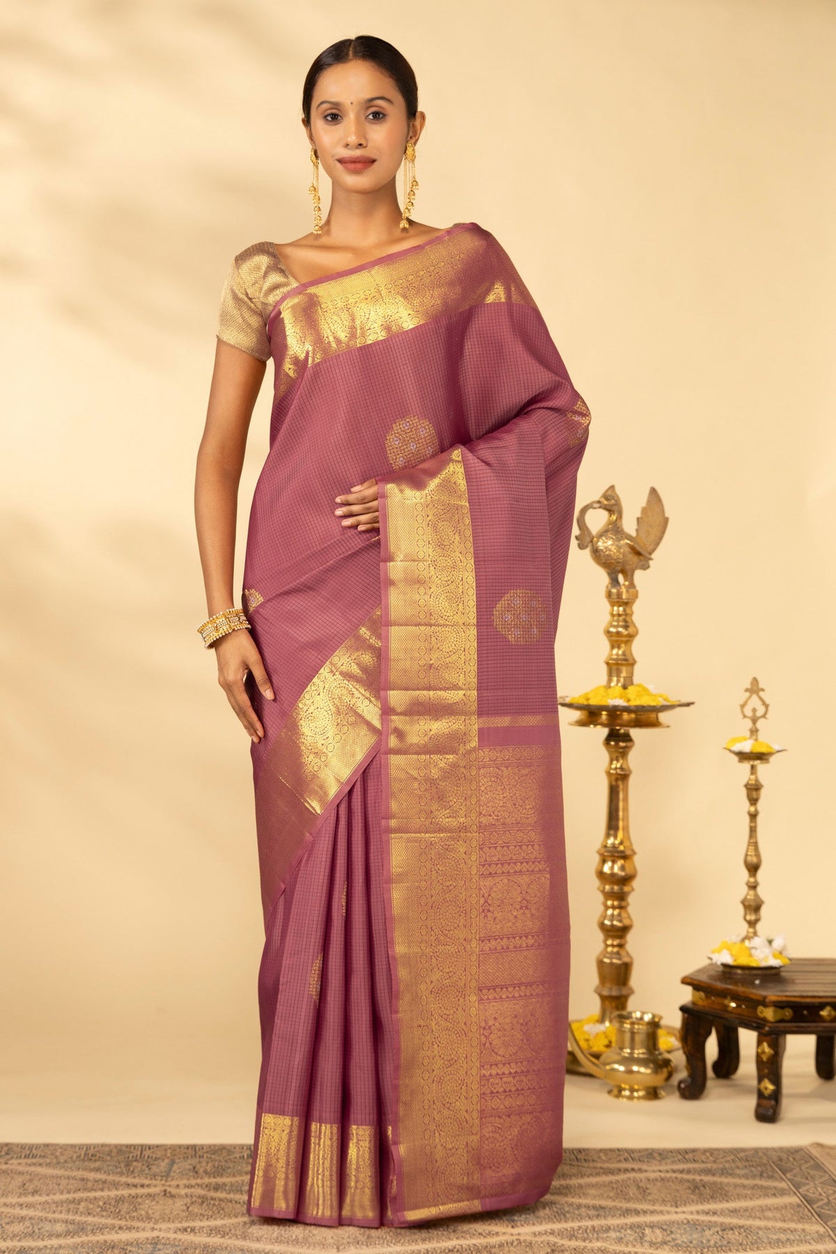 Coral Kanchipuram Silk Saree with Checked design on the body and Zari Border displayed on a mannequin