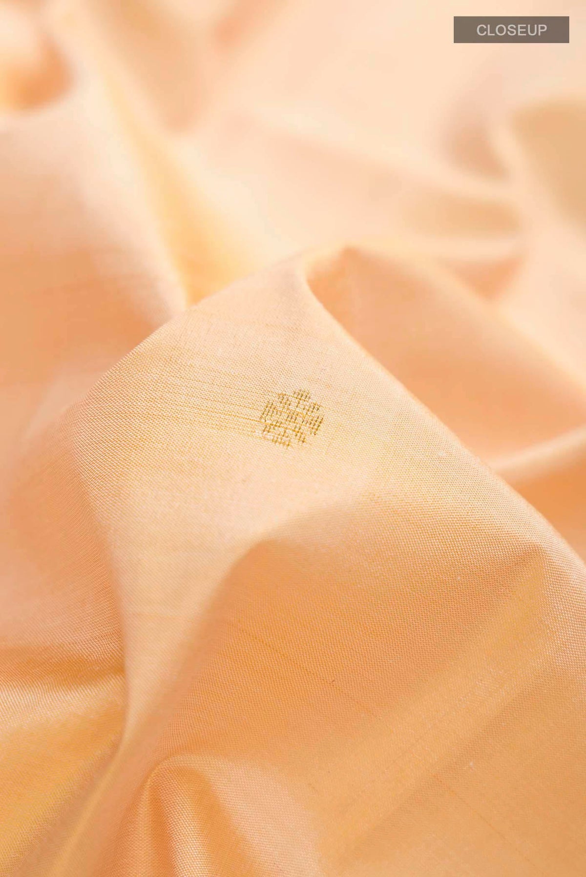 Close up of Pure Silk Pure Zari Sandal Kanchipuram Saree with Zari Butta on the body and Plain Border displaying folds