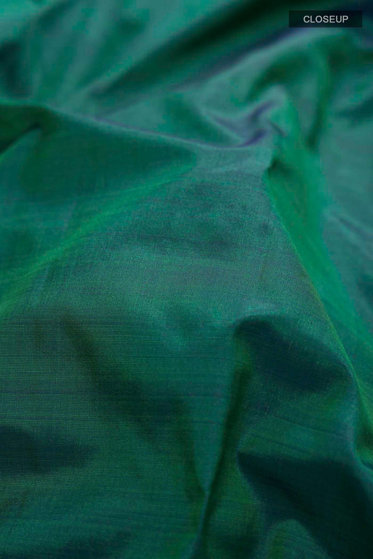 Close up of Green Kanchipuram Silk Nine Yards Saree with Plain Body and Zari Border displaying folds