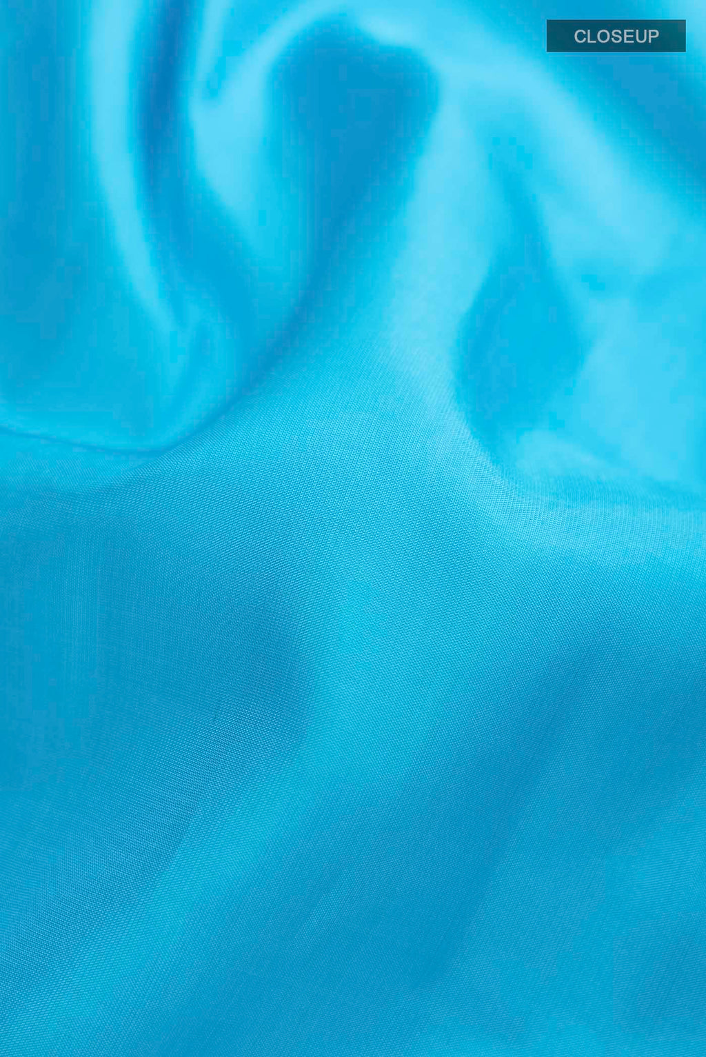 Close up of Blue Kanchipuram Silk Saree with Plain Body and Zari Border displaying folds