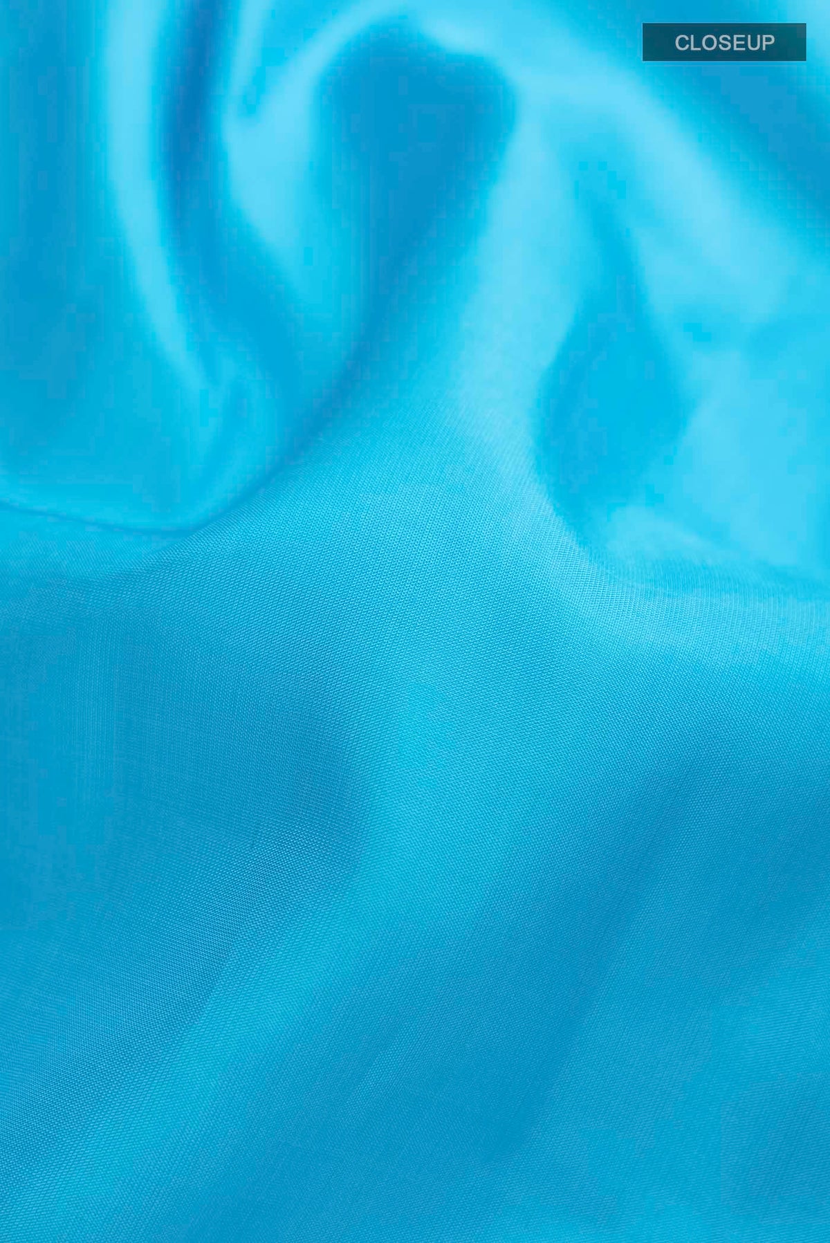 Close up of Blue Kanchipuram Silk Saree with Plain Body and Zari Border displaying folds