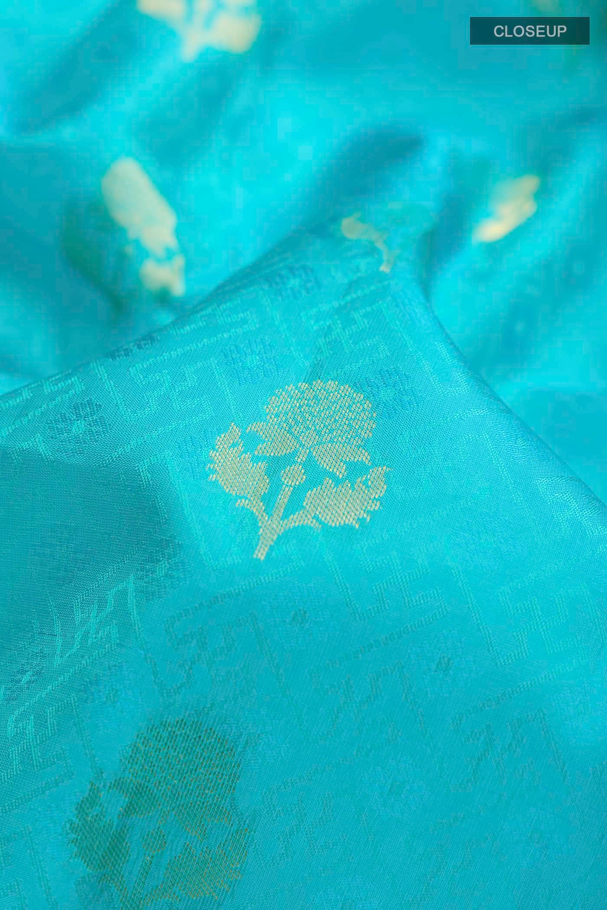 Close up of Blue Kanchipuram Silk Saree with Jacquard With Zari Butta on the body and Zari Border displaying folds