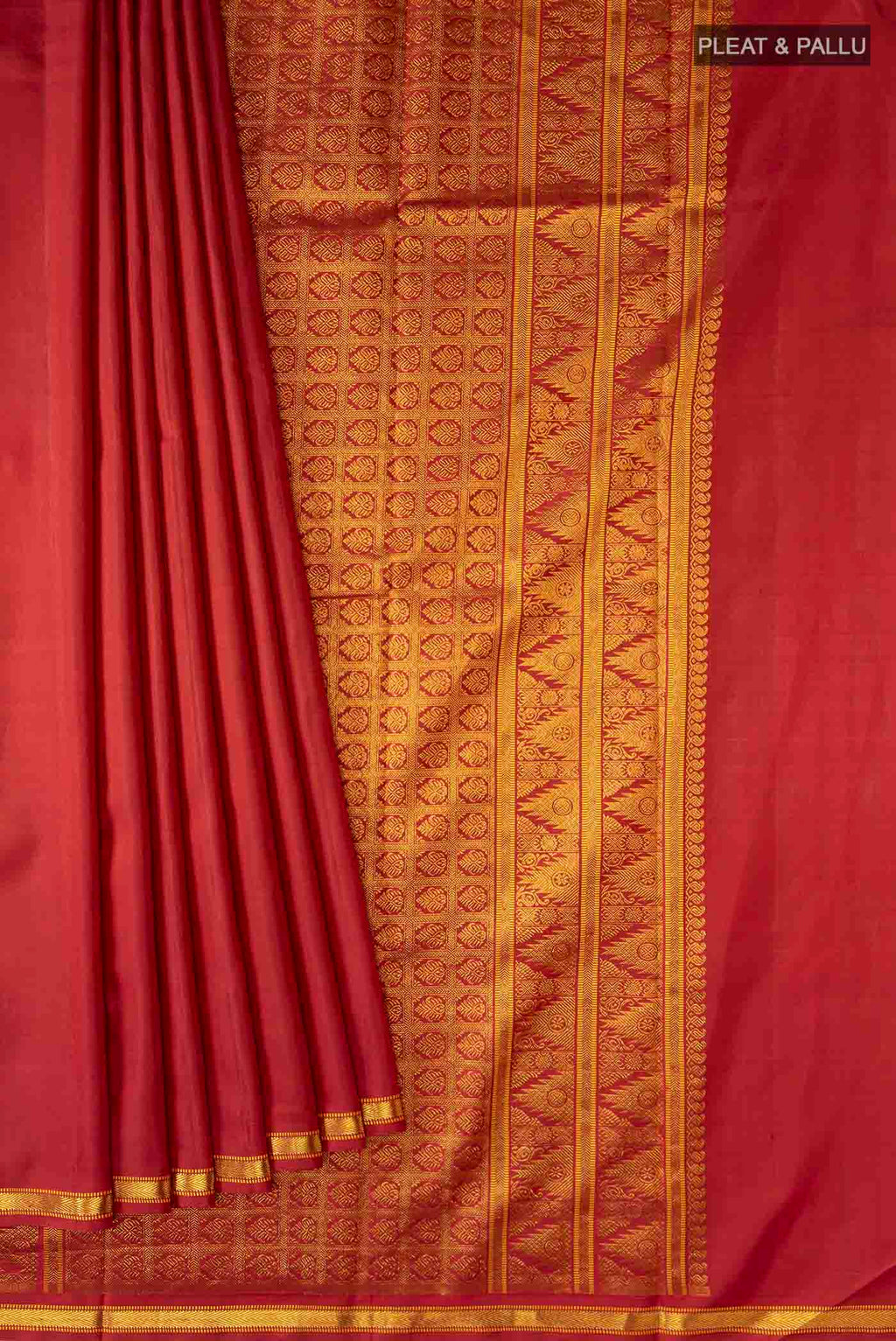 Pleats and pallu of Maroon Kanchipuram Silk Saree with Zari Butta on the body and Zari Border