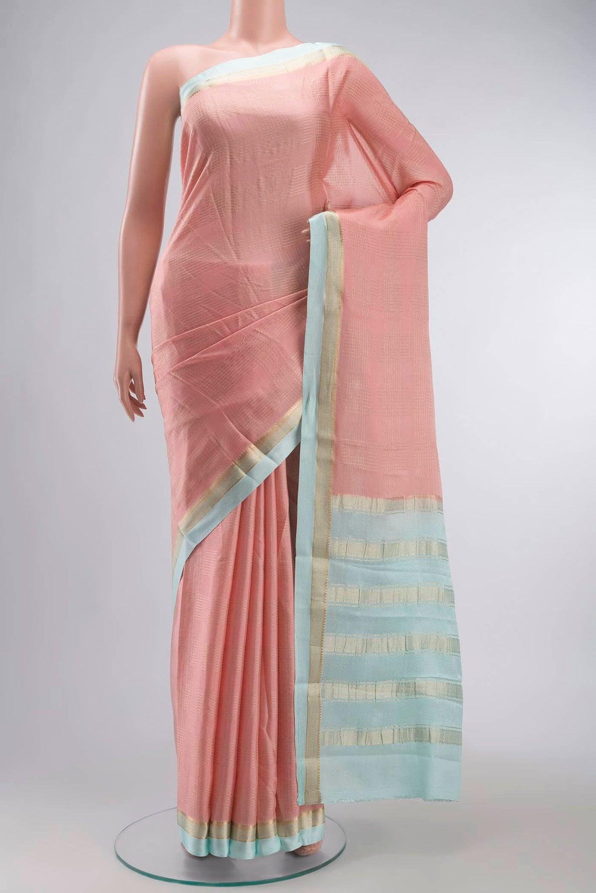 Peach Mysore Crepe Saree with Checked design on the body and Zari Border displayed on a mannequin