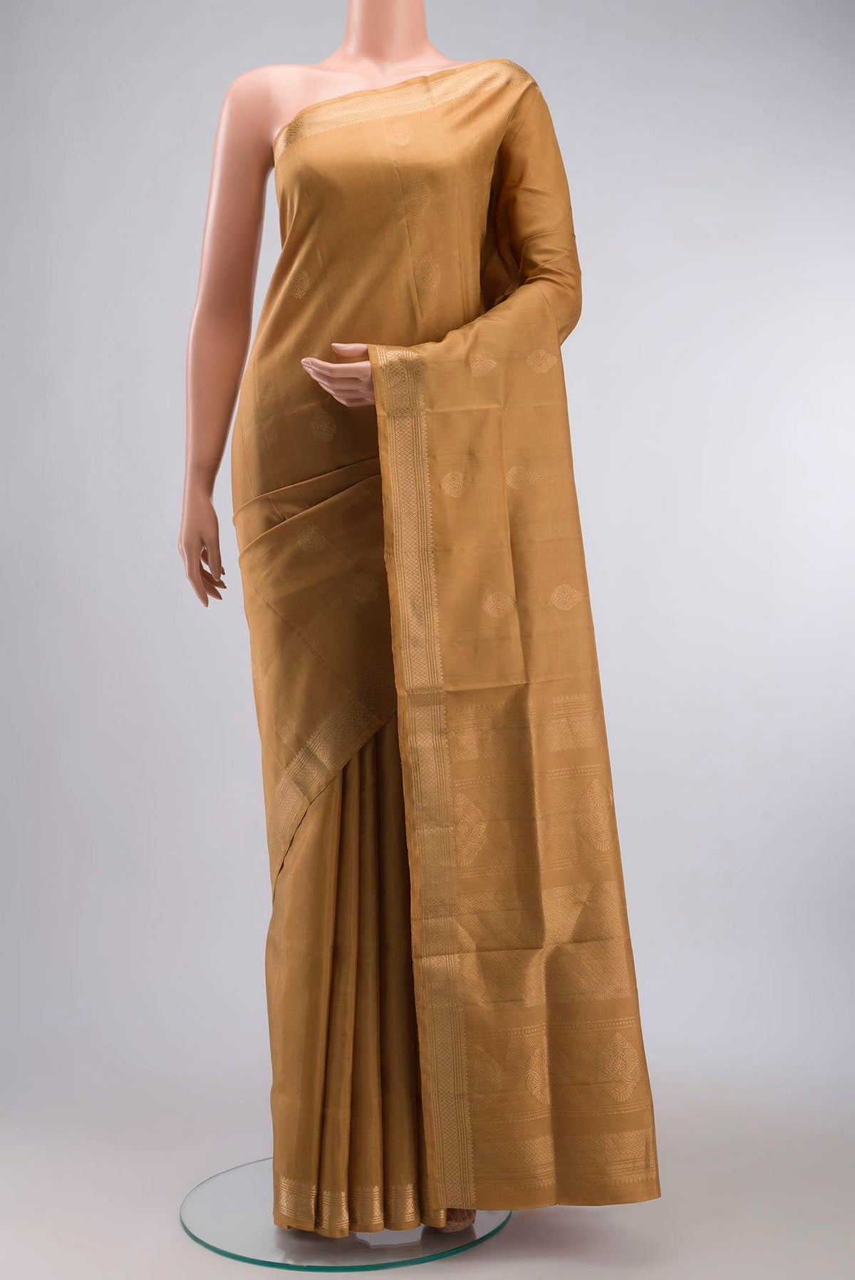 Brown Soft Silk Saree with Zari Butta on the body and Zari Border displayed on a mannequin