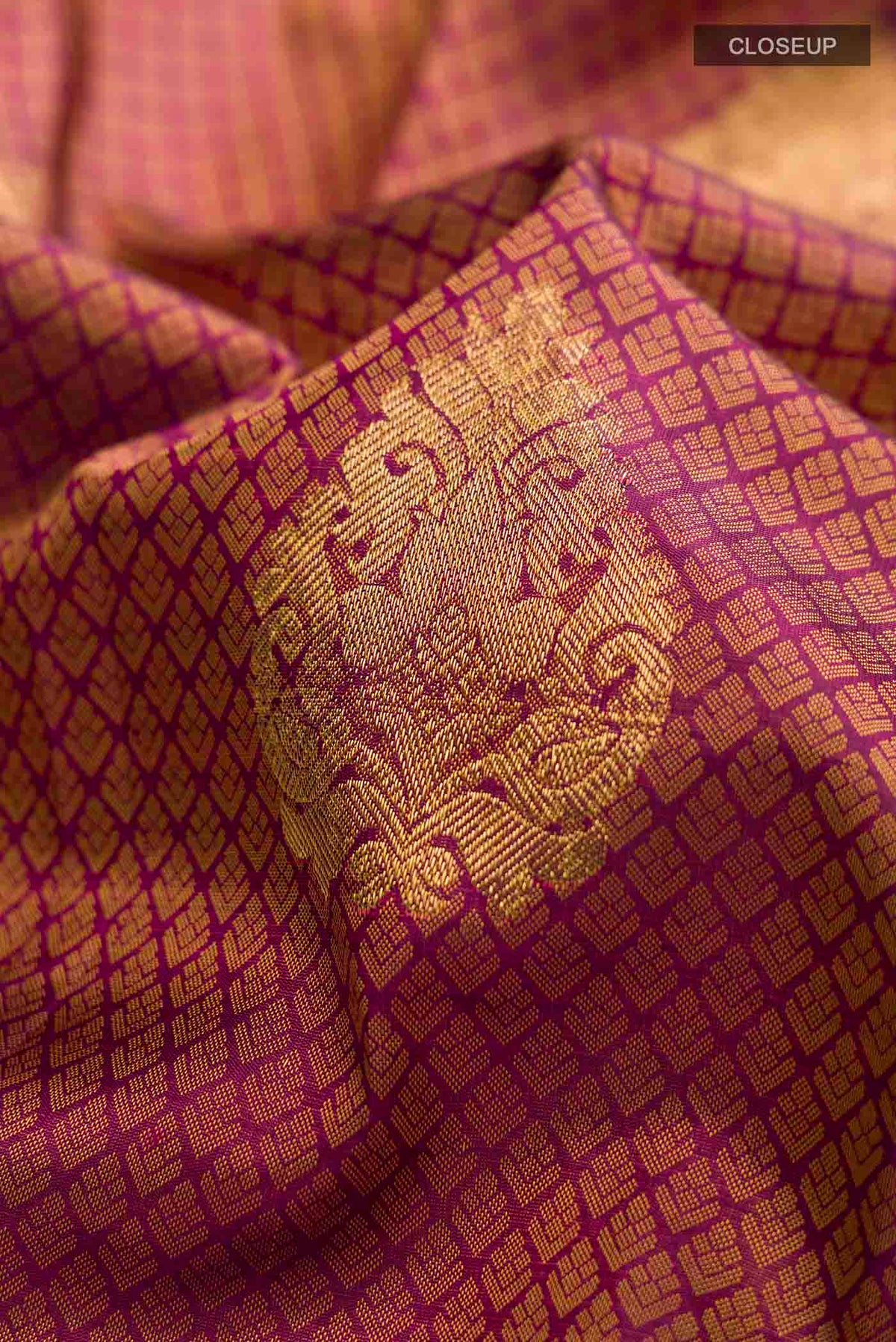 Close up of Maroon Kanchipuram Silk Saree with Jacquard With Zari Butta on the body and Zari Border displaying folds