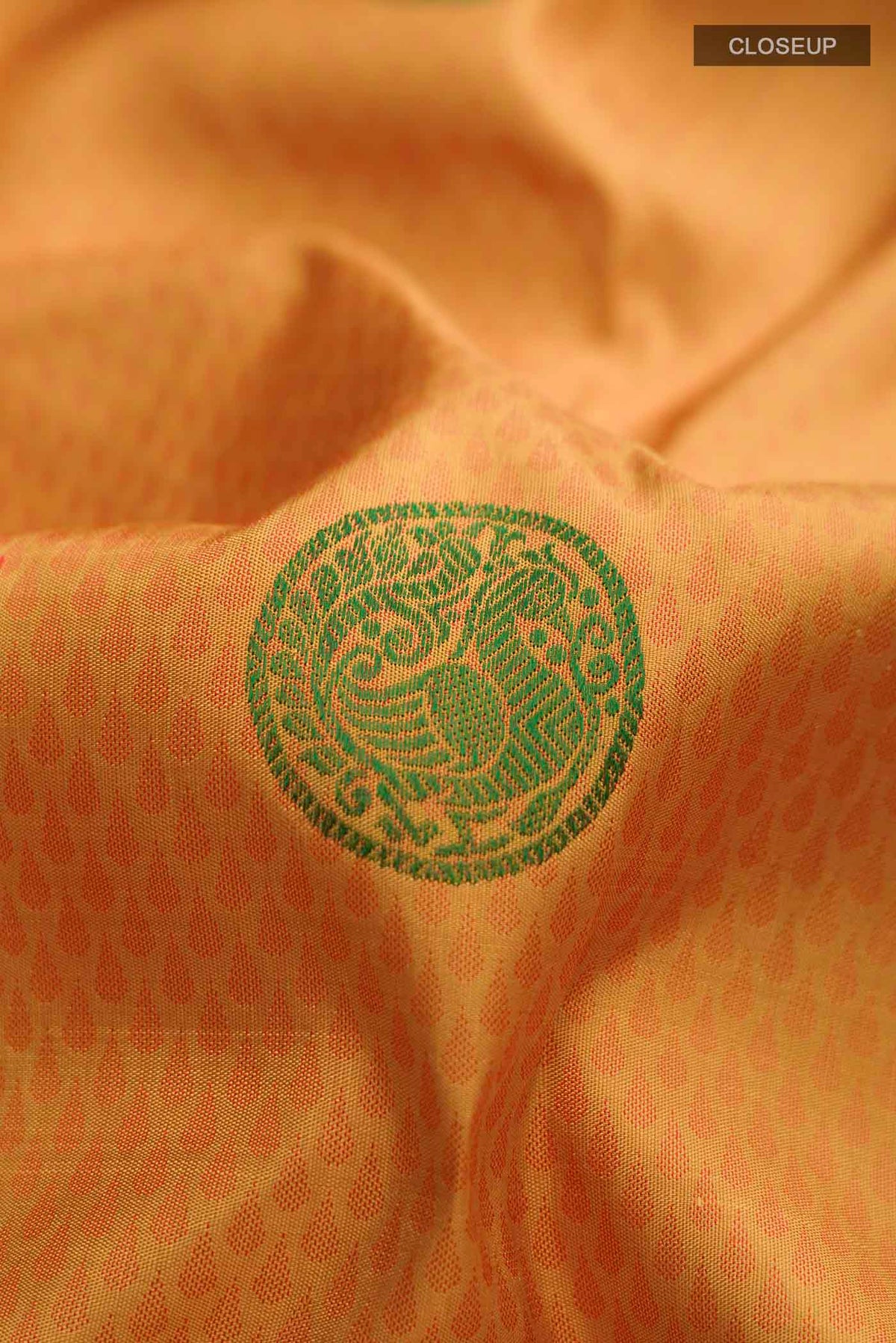 Close up of Yellow Kanchipuram Silk Saree with Jacquard design on the body and Zari Border displaying folds