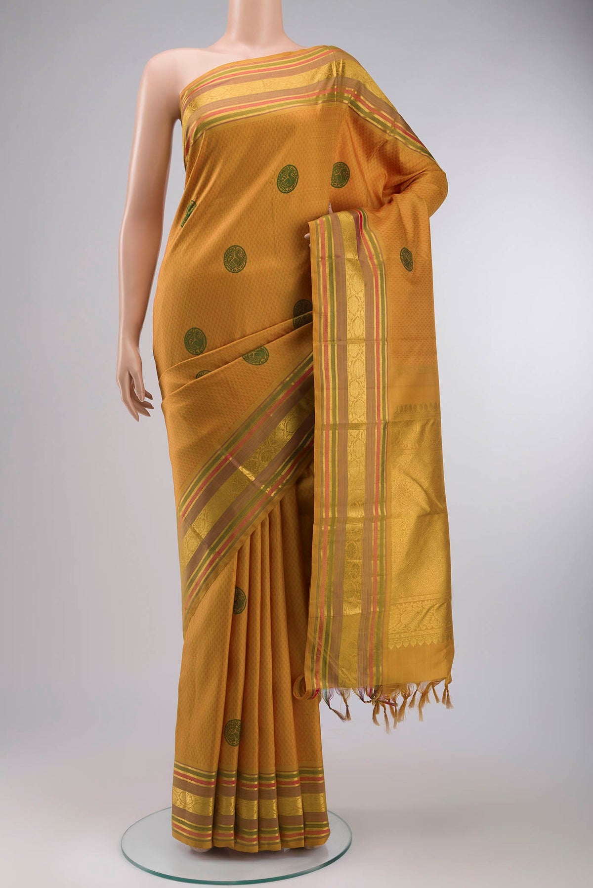 Yellow Kanchipuram Silk Saree with Jacquard design on the body and Zari Border displayed on a mannequin