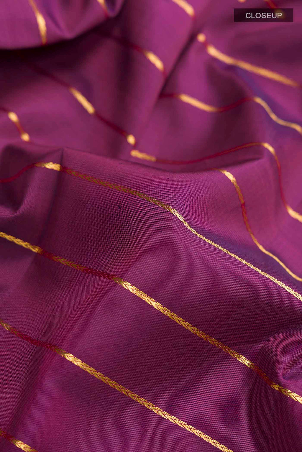 Close up of Purple Kanchipuram Silk Saree with Stripes on the body and Zari Border displaying folds