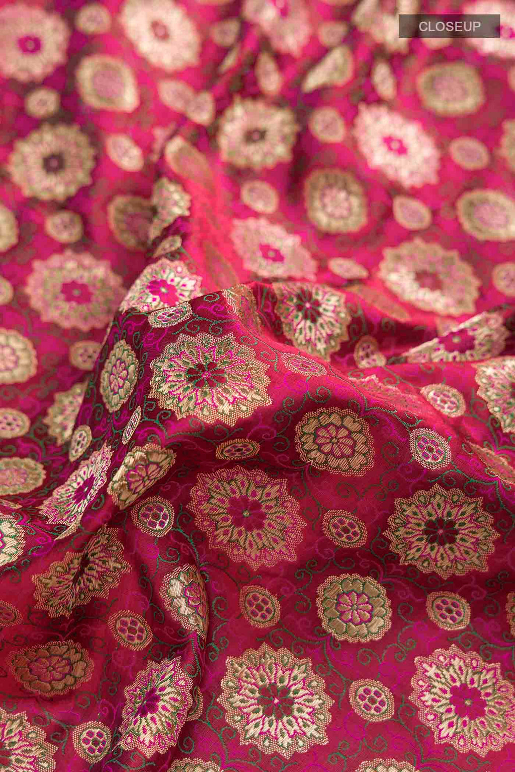 Close up of Pink Banarasi Silk Saree with Jacquard With Zari Butta on the body and Zari Border displaying folds