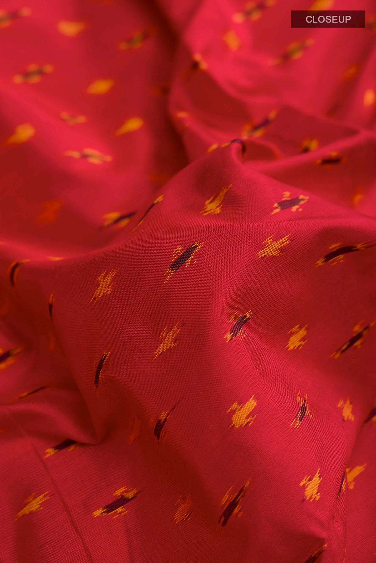 Close up of Red Pochampally Silk Saree with Pure Ikat on the body and Zari Border displaying folds