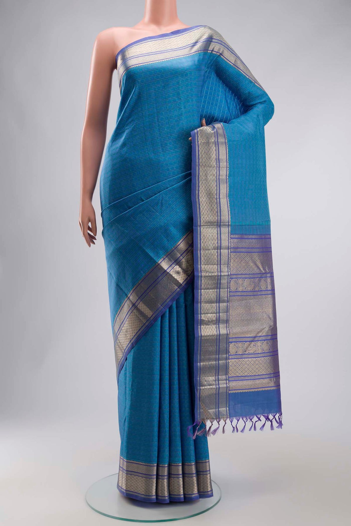 Blue Kanchipuram Silk Saree with Thread Butta on the body and Zari Border displayed on a mannequin